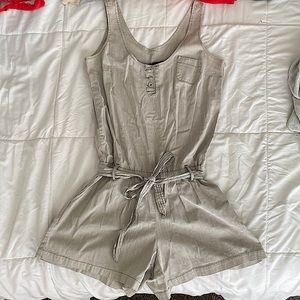 Striped cotton romper with pockets and tie waist.